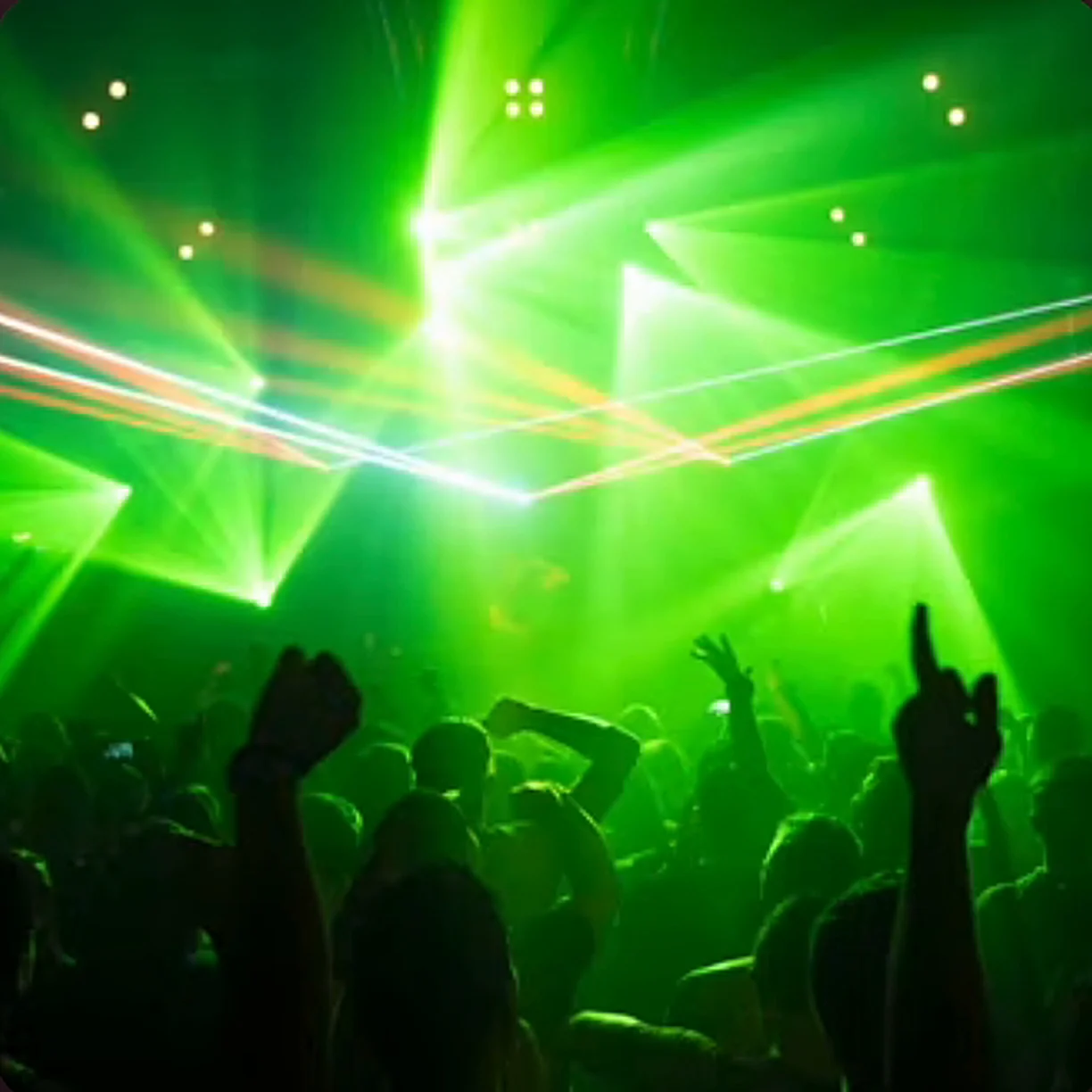 Green party lights over a dancing crowd