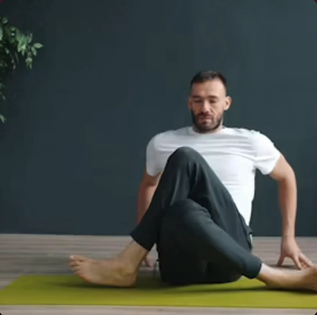 Man stretching on a green yoga mat