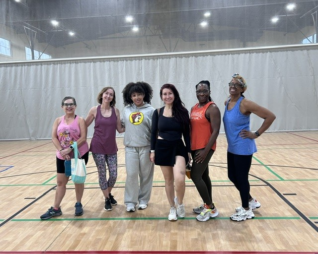 Group of students smiling together after an energetic class